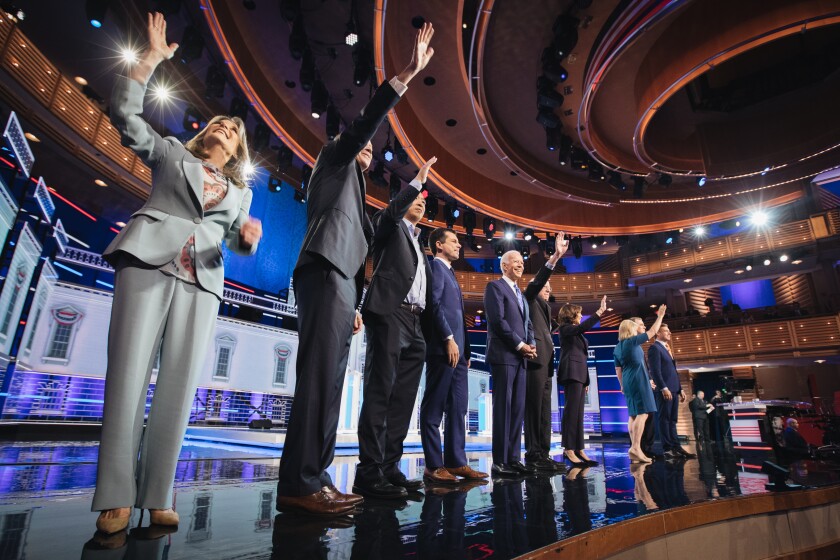 2020 Democratic presidential candidates Marianne Williamson, author, from left, John Hickenlooper, former governor of Colorado, Andrew Yang, founder of Venture for America, Pete Buttigieg, mayor of South Bend, former U.S. Vice President Joe Biden, Senator Bernie Sanders, an independent from Vermont, Senator Kamala Harris, a Democrat from California, Senator Kirsten Gillibrand, a Democrat from New York, Senator Michael Bennet, a Democrat from Colorado, and Representative Eric Swalwell, a Democrat from California, stand on stage during the Democratic presidential candidate debate in Miami.
